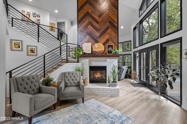 706 N Hulet Ln, Flagstaff, AZ 86004 - living room with a high ceiling, stairs, wood finished floors, a brick fireplace, and recessed lighting