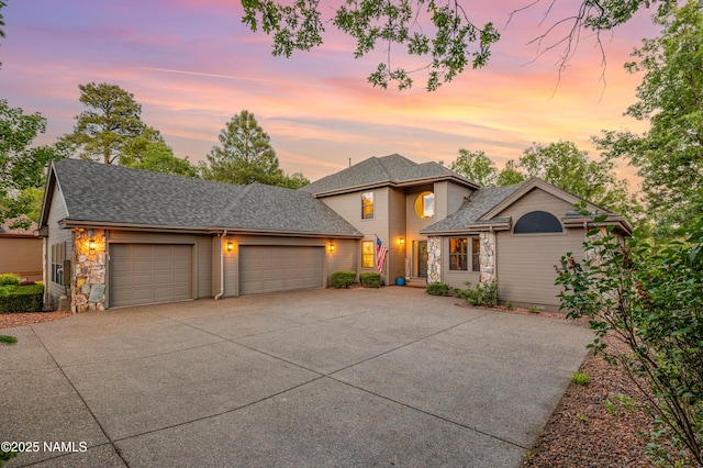 706 N Hulet Ln, Flagstaff, AZ 86004 - traditional-style house with driveway, a garage, roof with shingles, and stone siding