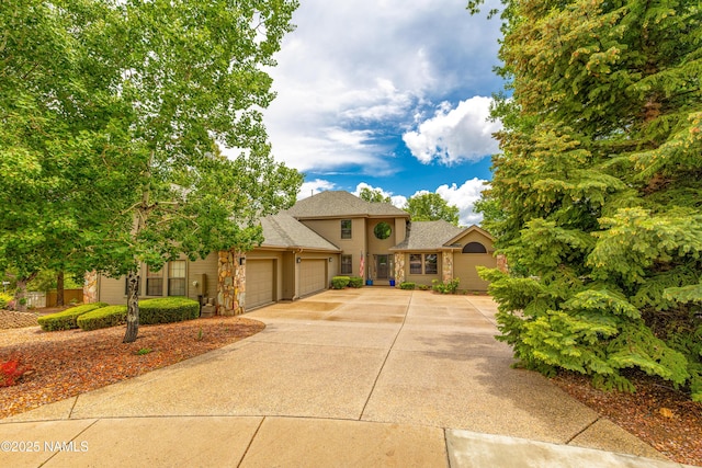 706 N Hulet Ln, Flagstaff, AZ 86004 - traditional home featuring an attached garage, driveway, and a shingled roof