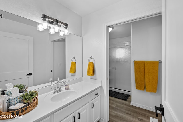 706 N Hulet Ln, Flagstaff, AZ 86004 - bathroom featuring vanity, a stall shower, and wood finished floors