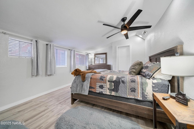 bedroom featuring hardwood / wood-style flooring, ceiling fan, and vaulted ceiling