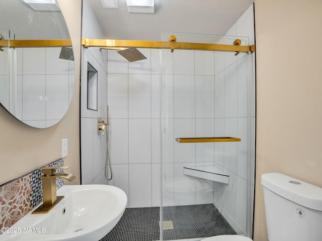 bathroom with sink, toilet, and walk in shower