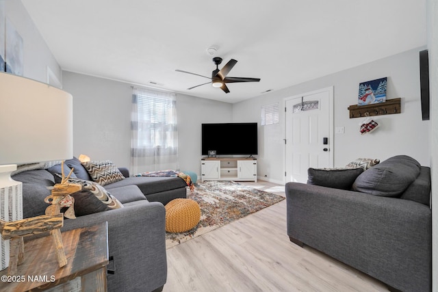 living room featuring ceiling fan and light hardwood / wood-style flooring