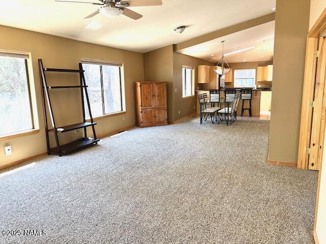 39 E Oak Dr, Munds Park, AZ 86017 - living area featuring vaulted ceiling, carpet flooring, a ceiling fan, and baseboards