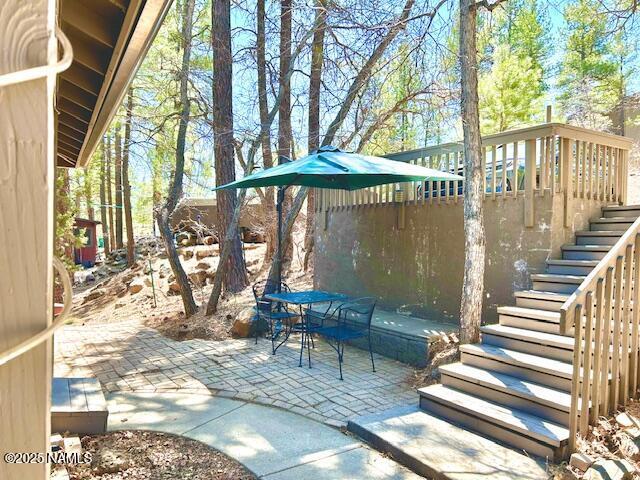 39 E Oak Dr, Munds Park, AZ 86017 - view of patio / terrace featuring stairway and outdoor dining space