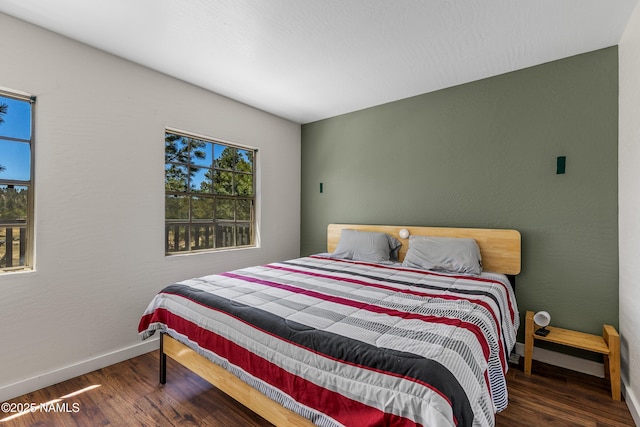5552 White Tail Ln, Flagstaff, AZ 86005 - bedroom featuring baseboards, multiple windows, and wood finished floors
