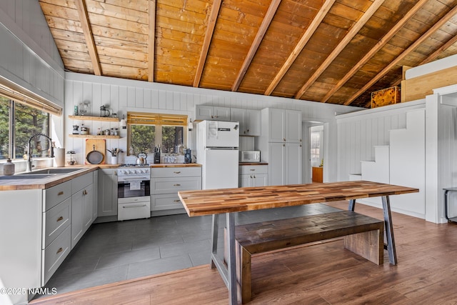 5552 White Tail Ln, Flagstaff, AZ 86005 - kitchen with vaulted ceiling with beams, wood ceiling, and white appliances