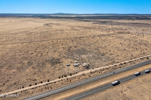 bird's eye view with a rural view, a mountain view, and view of desert