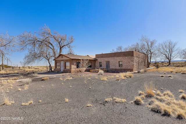 southwest-style home featuring driveway and stucco siding