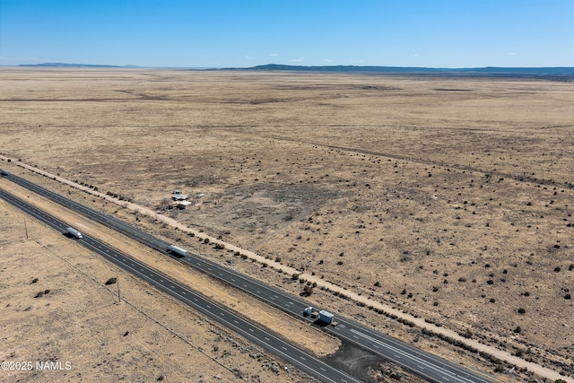 aerial view featuring a mountain view, a desert view, and a rural view