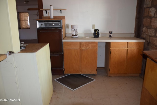 kitchen featuring light countertops and brown cabinets