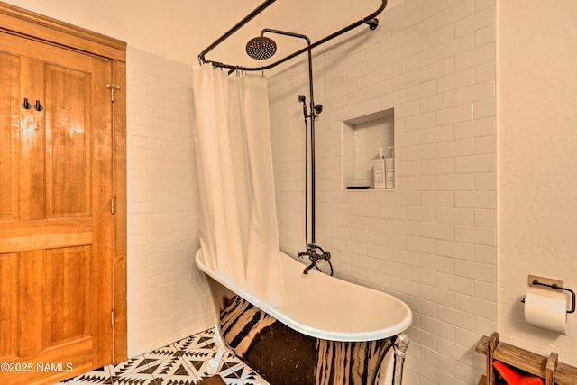 bathroom featuring tile walls and shower / bath combo with shower curtain