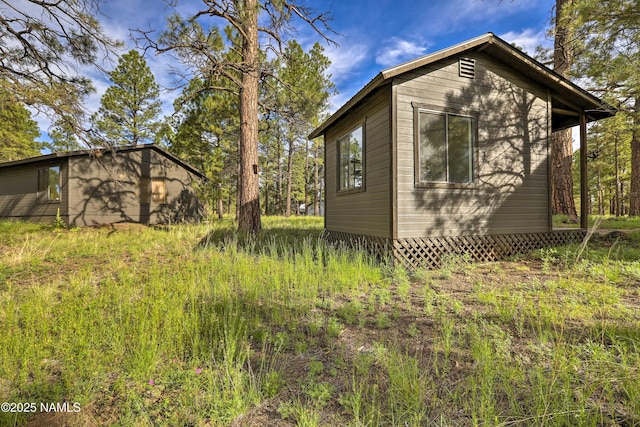 view of property exterior with an outbuilding