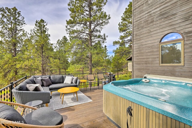 deck featuring a hot tub and an outdoor hangout area