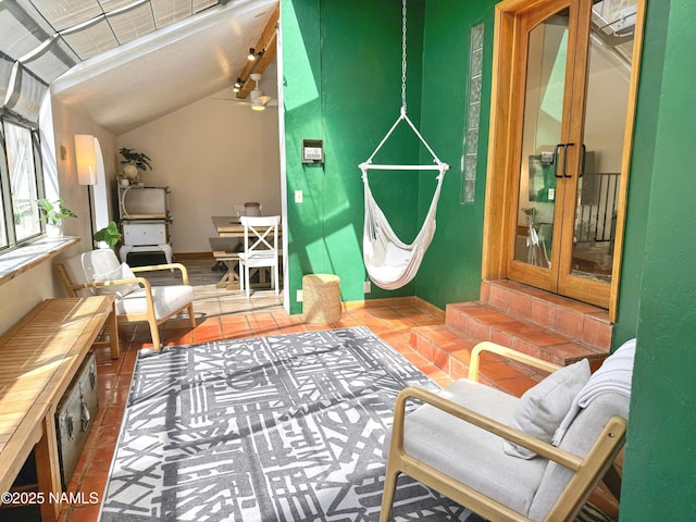 interior space featuring vaulted ceiling and dark tile patterned floors