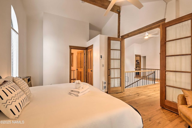 bedroom featuring beamed ceiling, wood-type flooring, and high vaulted ceiling