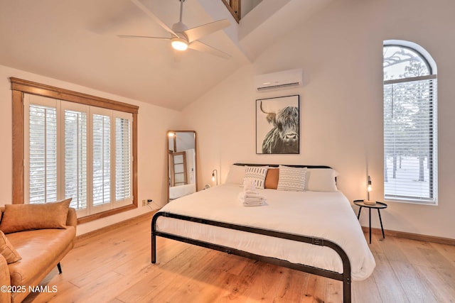 bedroom with light hardwood / wood-style floors, vaulted ceiling, multiple windows, and an AC wall unit