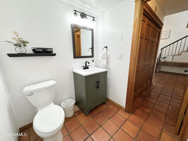 bathroom with vanity, tile patterned flooring, and toilet