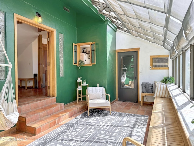 interior space with vaulted ceiling and a wall mounted AC