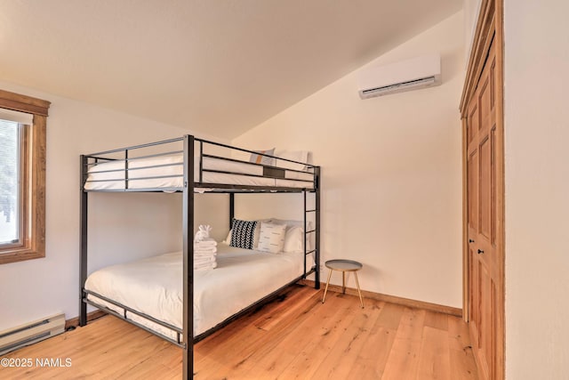 unfurnished bedroom with vaulted ceiling, a wall mounted AC, light hardwood / wood-style floors, and a baseboard heating unit