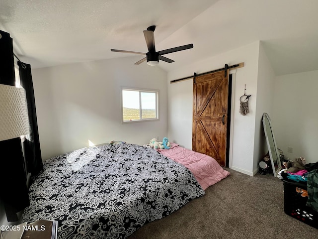 bedroom with vaulted ceiling, carpet floors, a barn door, and a ceiling fan