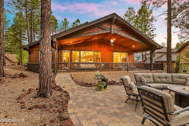 3480 W Lead Rope, Flagstaff, AZ 86005 - patio terrace at dusk with outdoor lounge area, a patio, and covered porch