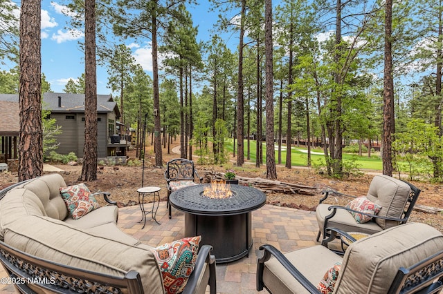 3480 W Lead Rope, Flagstaff, AZ 86005 - view of patio / terrace featuring an outdoor living space with a fire pit and view of scattered trees