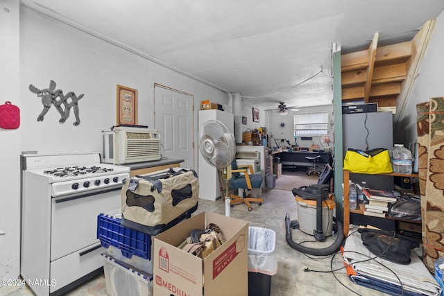 kitchen with white gas range and a ceiling fan