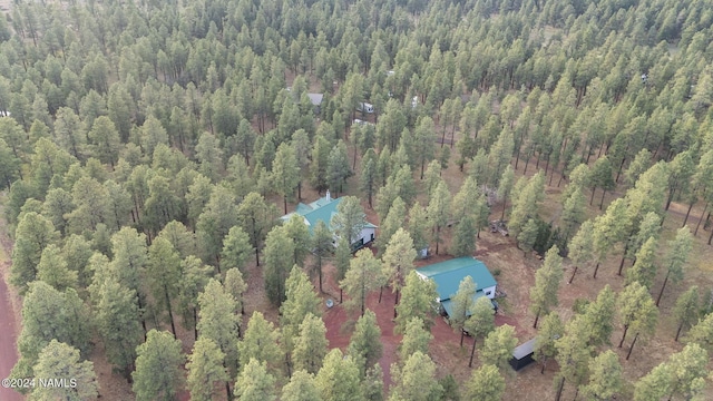 drone / aerial view featuring a wooded view