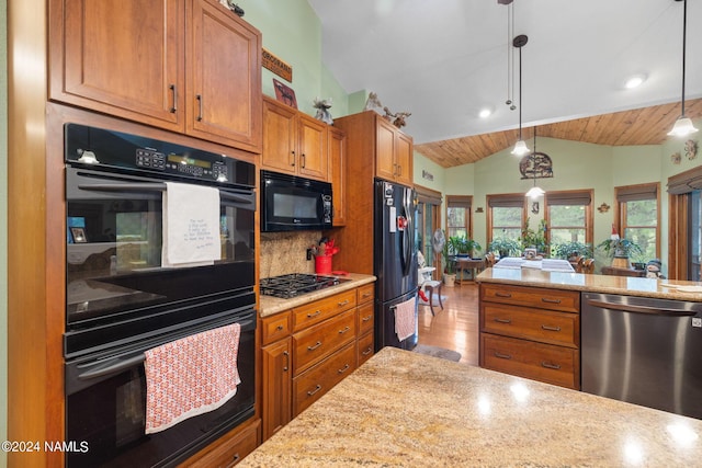 kitchen featuring pendant lighting, black appliances, brown cabinetry, decorative backsplash, and lofted ceiling