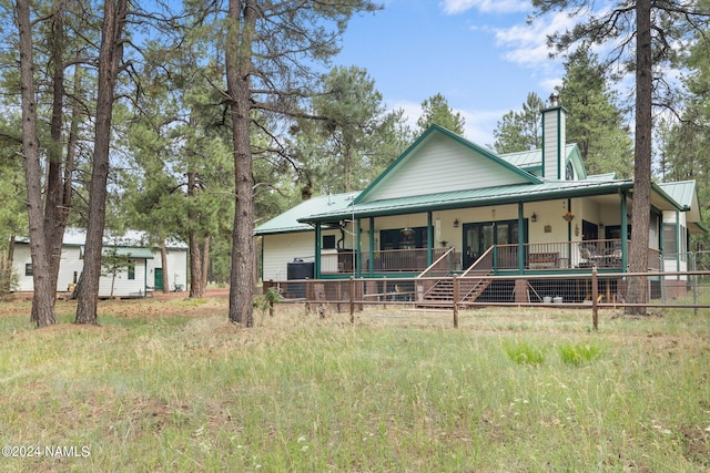 view of front of home featuring metal roof and a chimney