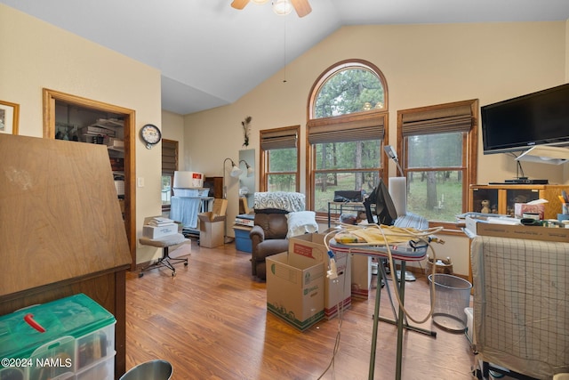 home office with high vaulted ceiling, wood finished floors, and ceiling fan