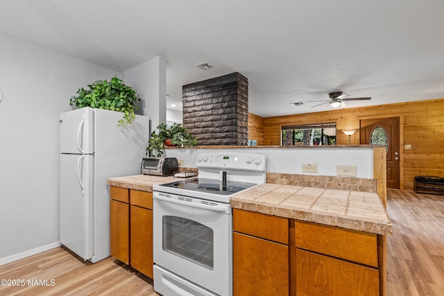 840 E Caribou Rd, Munds Park, AZ 86017 - kitchen featuring white appliances, tile counters, light wood-style flooring, a peninsula, and ceiling fan