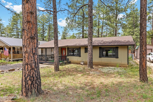 840 E Caribou Rd, Munds Park, AZ 86017 - view of front facade with roof with shingles and a porch