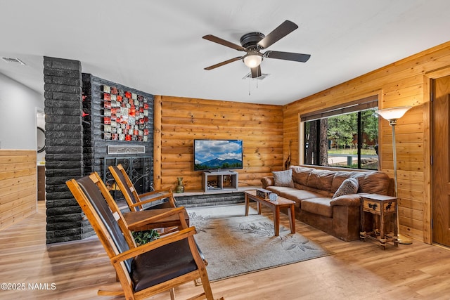 840 E Caribou Rd, Munds Park, AZ 86017 - living area featuring wood finished floors, a ceiling fan, and log walls