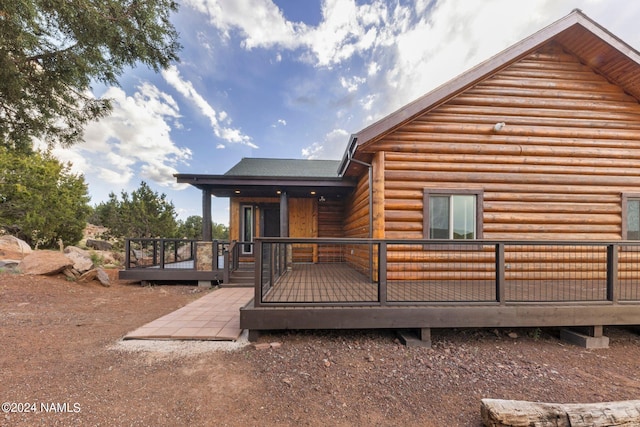 back of property featuring a wooden deck