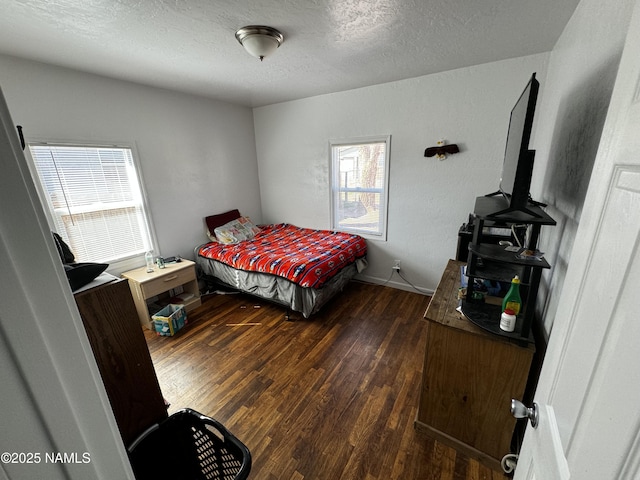 bedroom with a textured ceiling and wood finished floors