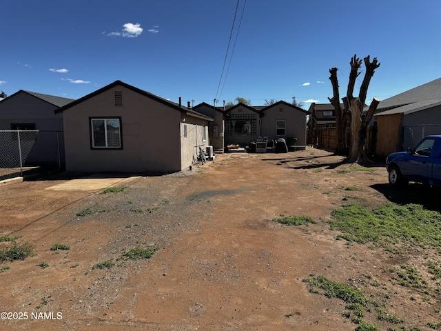 view of property exterior with fence and stucco siding