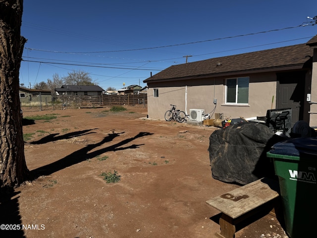 view of yard with ac unit and fence