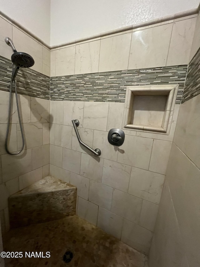 full bathroom featuring tiled shower