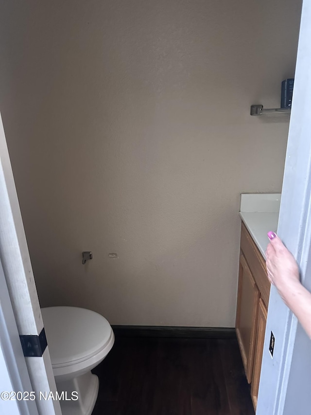 255 S Beech Dr, Flagstaff, AZ 86004 - bathroom with baseboards, toilet, vanity, and wood finished floors