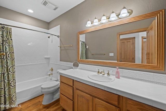 full bath with visible vents, toilet, shower / bath combo, wood finished floors, and vanity