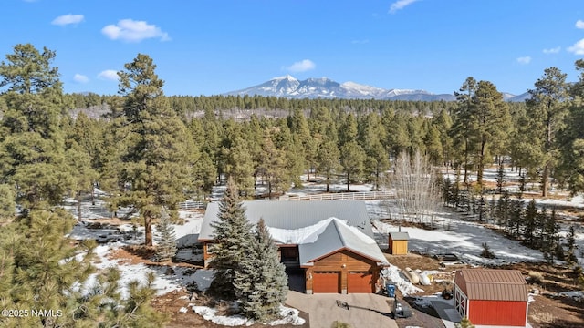 birds eye view of property featuring a mountain view and a forest view