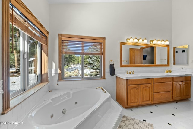 bathroom featuring a sink, a jetted tub, and double vanity