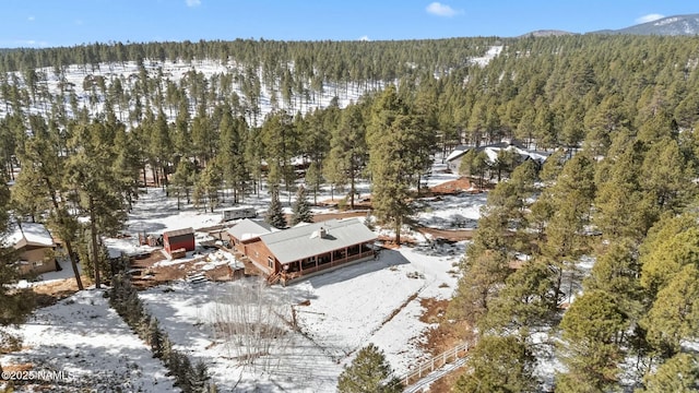 snowy aerial view with a forest view