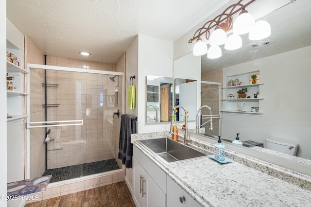1125 Trails End Dr, Sedona, AZ 86336 - full bath featuring vanity, toilet, a shower stall, wood finished floors, and a textured ceiling