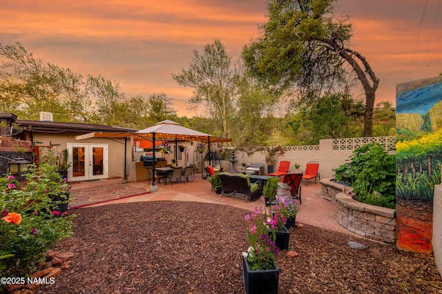 1125 Trails End Dr, Sedona, AZ 86336 - yard at dusk with french doors and a patio area