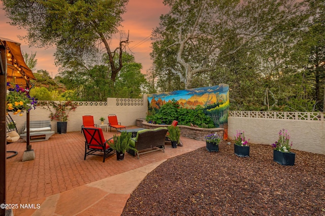 1125 Trails End Dr, Sedona, AZ 86336 - patio terrace at dusk with a patio area and a fenced backyard