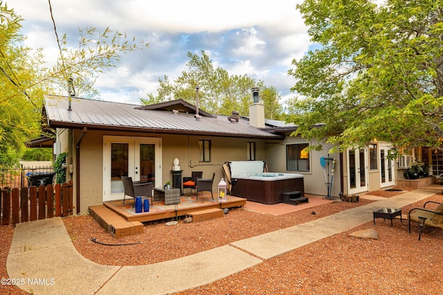 1125 Trails End Dr, Sedona, AZ 86336 - rear view of house featuring french doors, a hot tub, stucco siding, and metal roof