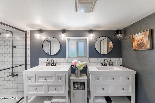 bathroom featuring vanity, tile walls, and tasteful backsplash